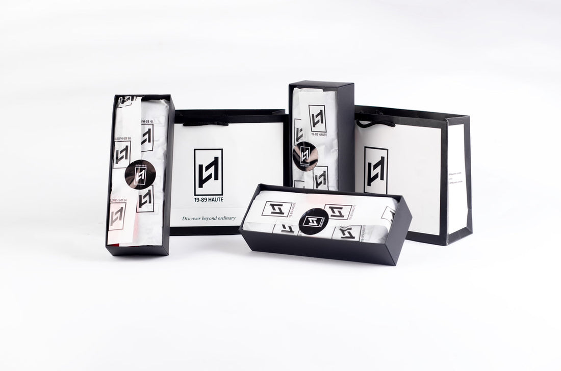 Minimalist luxury packaging of 19-89 Haute men’s underwear, featuring black matte box, branded tissue wrap, and thank-you card—designed for a premium unboxing experience.