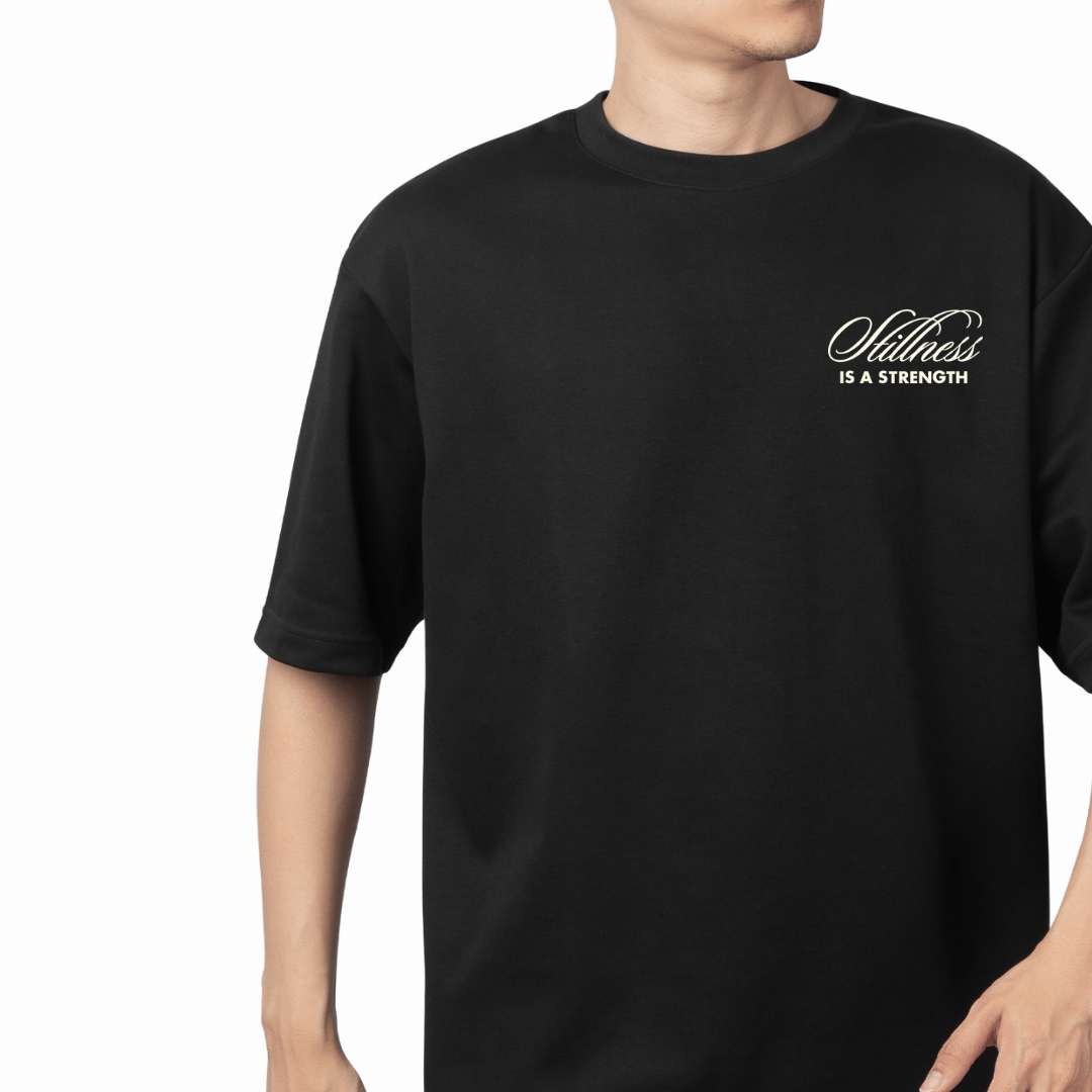 Black Oversized T-shirt with minimalist chest embroidery "Stillness is Strength" by 19:89 Haute